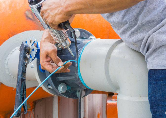 Plumber is welding off the leak of PVC pipe