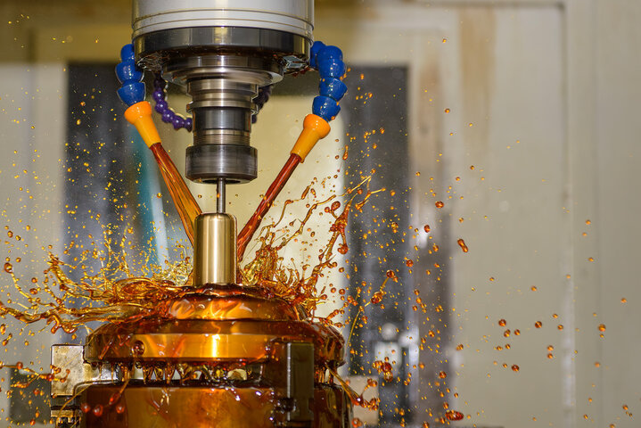 The CNC milling machine cutting the shell mold parts with oil coolant method