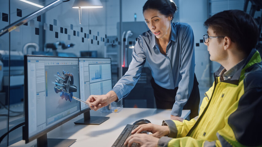 Professionals Working on CNC Machinery and Robot Arm Production Line